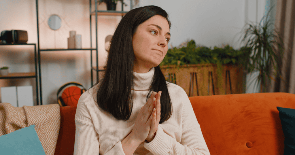 A woman sits calmly with a knowing look, embodying the quiet power of an unexpected response to a narcissist.