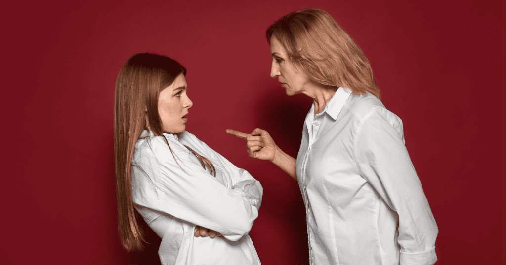 An older woman points an accusatory finger at a younger woman who leans back with a startled expression, capturing the volatile reaction that occurs when someone’s dominance in a relationship is no longer acknowledged.