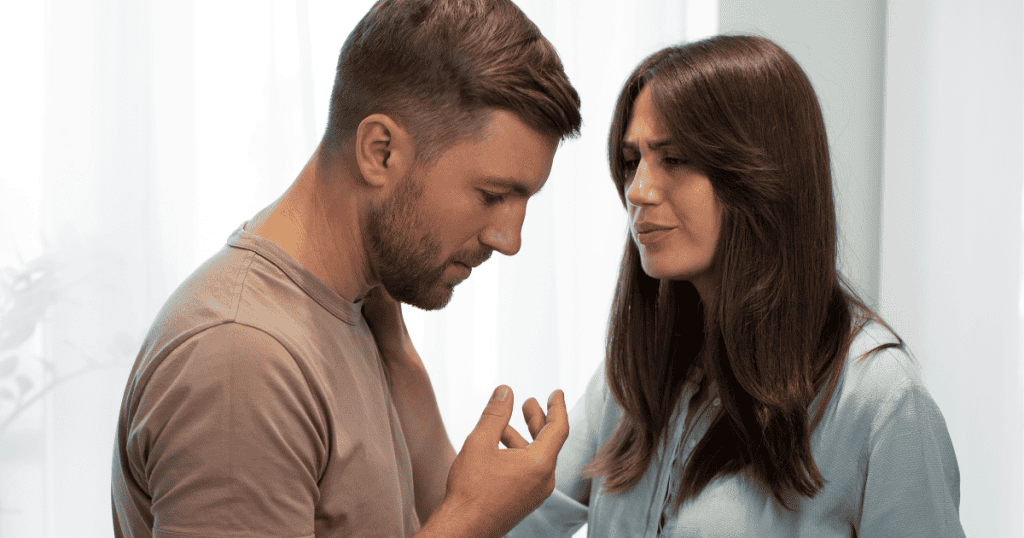 A woman gazes intensely at a man who is gesturing with his hands, illustrating the desperate, physical strain of trying to bridge a gap in perception.