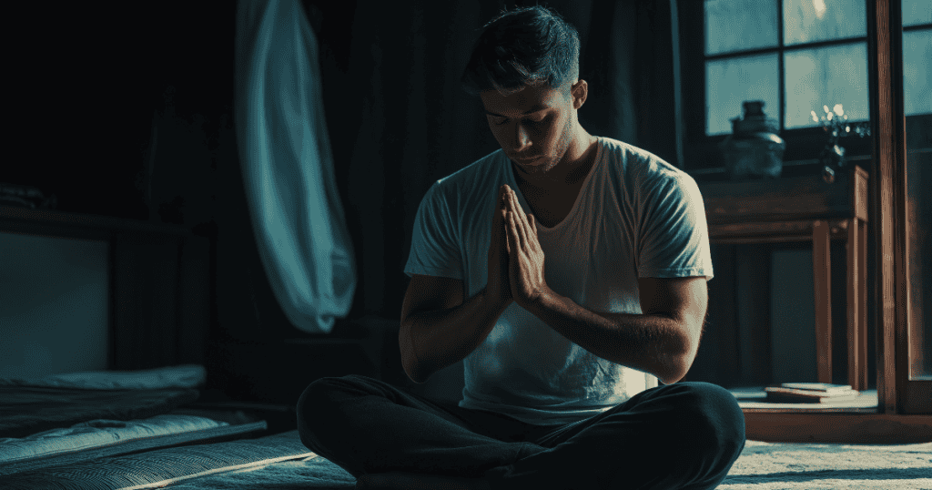 A man sits cross-legged in a darkened room with clasped hands, desperately seeking internal clarity amidst a deeply confusing fog of psychological twisting.