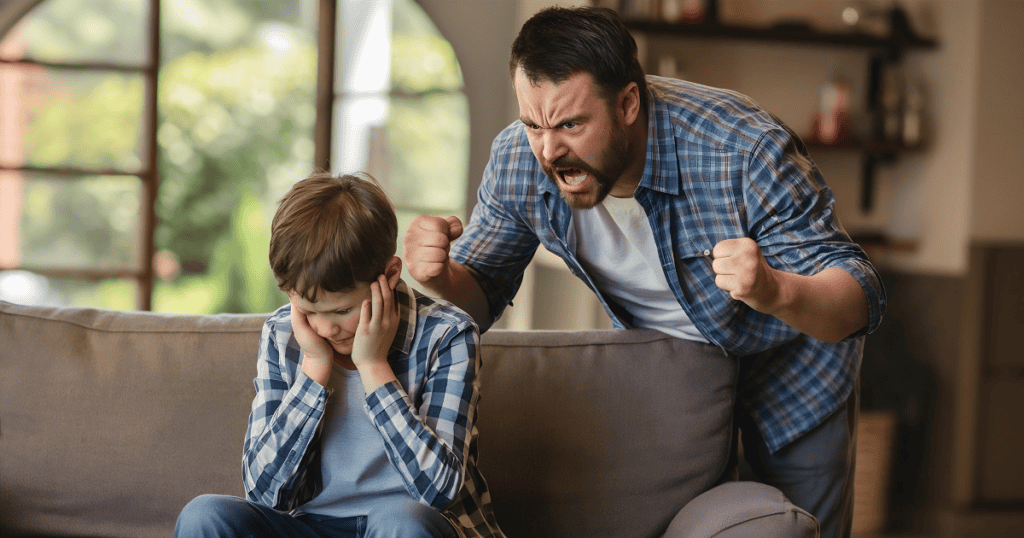 A man with a fierce expression gestures aggressively toward a boy covering his ears on a sofa, highlighting the intense pressure that necessitates firm protective boundaries.