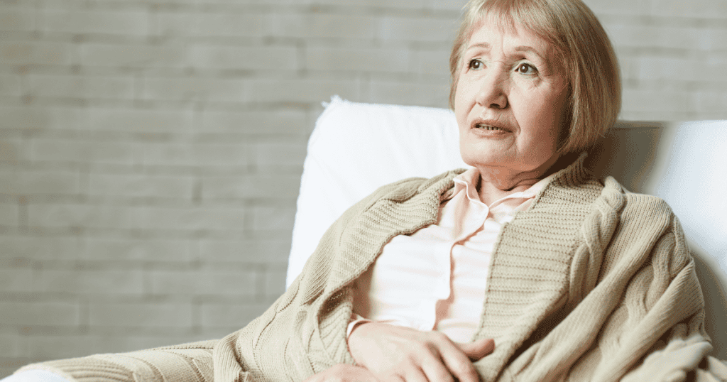 An elderly woman looks off-camera with a concerned expression, her frail appearance serving as a potent tool for emotional influence.
