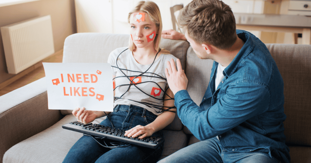 A woman sits tied in wires and covered in "like" stickers, illustrating a literal and metaphorical entrapment by the constant need for external validation.