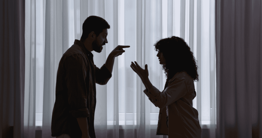 A man points aggressively at a woman during a tense silhouette confrontation, capturing the moment a choreographed dynamic finally shatters.