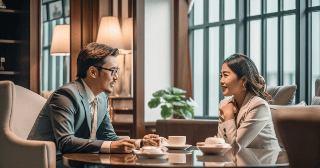 A man and woman sit across from each other at a small table, demonstrating a polished exchange that lacks the deeper movement needed for true change.