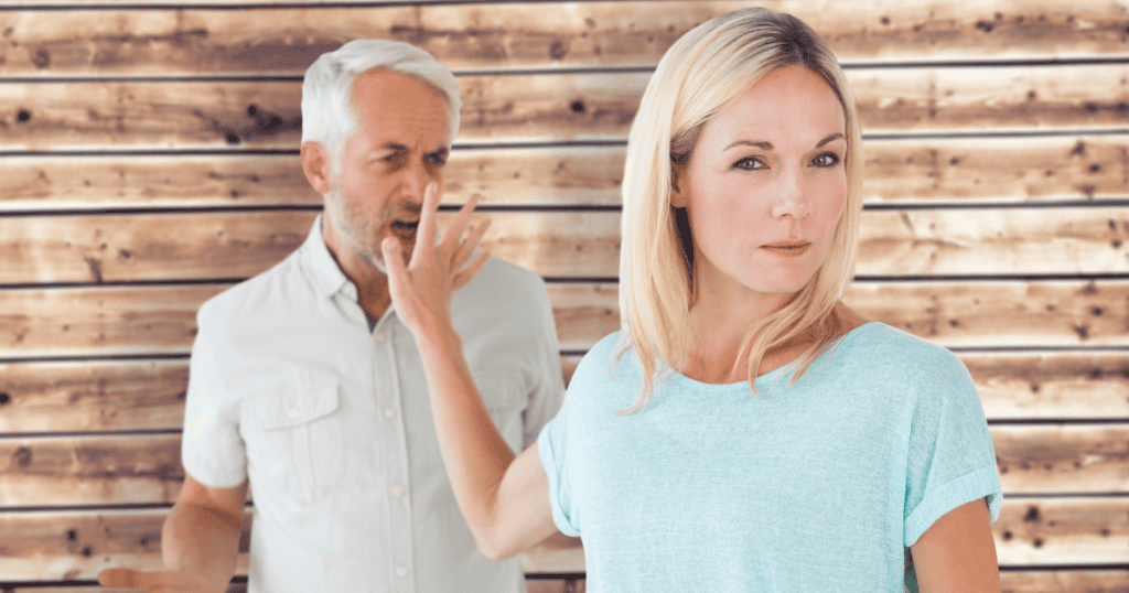 A woman looks forward with a stoic expression while a man shouts in the blurred background, existing as a fixed point for another's chaos.