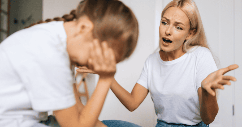 A blonde woman gestures exasperatedly while scolding a young girl covering her face, depicting the overwhelming emotional exhaustion caused by relentless criticism.