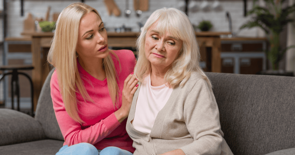 A young woman attentively comforting an older woman, reflecting how being raised by a narcissist programs you to instinctively prioritize everyone else's needs while neglecting your own.