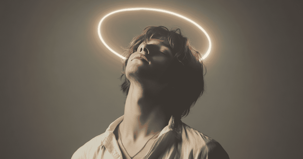 A young man tilts his head back with eyes closed beneath a glowing halo, symbolizing the self-righteous image a narcissist holds of themselves as a genuinely kind person.
