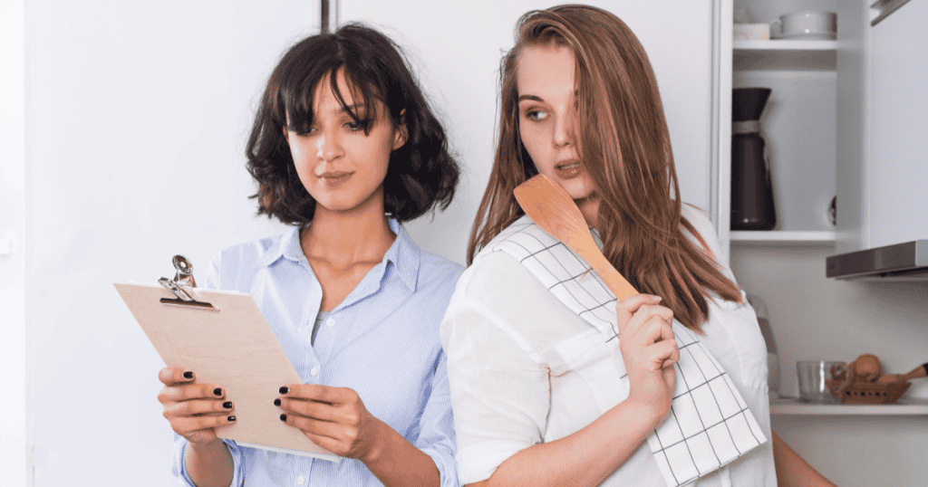 A woman with a wooden spoon eyes the woman beside her with quiet resentment, reflecting how an apology can stir up shame in a narcissist that quickly turns into blame.