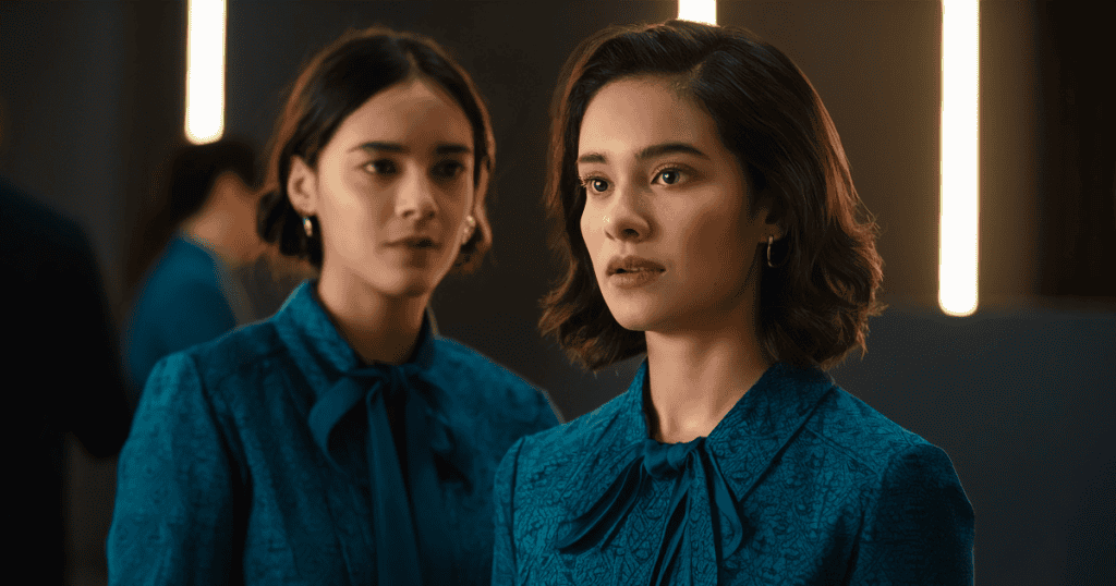 A woman in a matching outfit stands just behind another, watching her closely, reflecting how you can spend years shaping yourself around a narcissist and chasing their approval without realizing it.